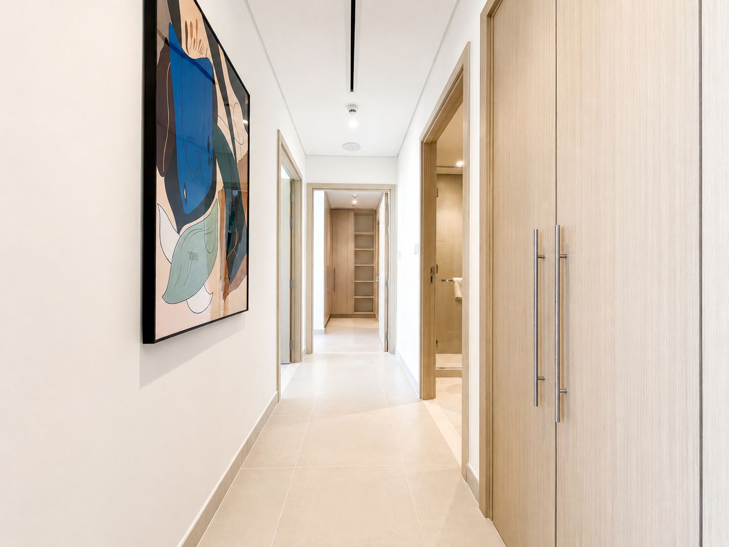 Hallway with curated artwork in a Dubai apartment